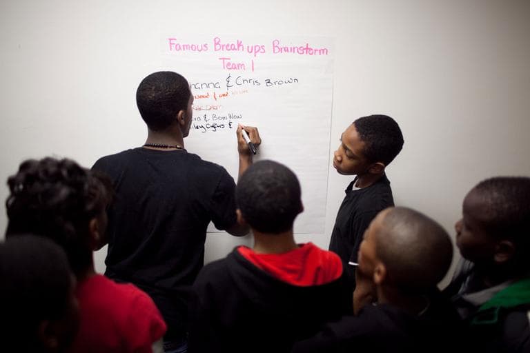 Students look on as another lists famous breakups. Rihanna and Chris Brown were at the top of the list. (Nick Dynan for WBUR)