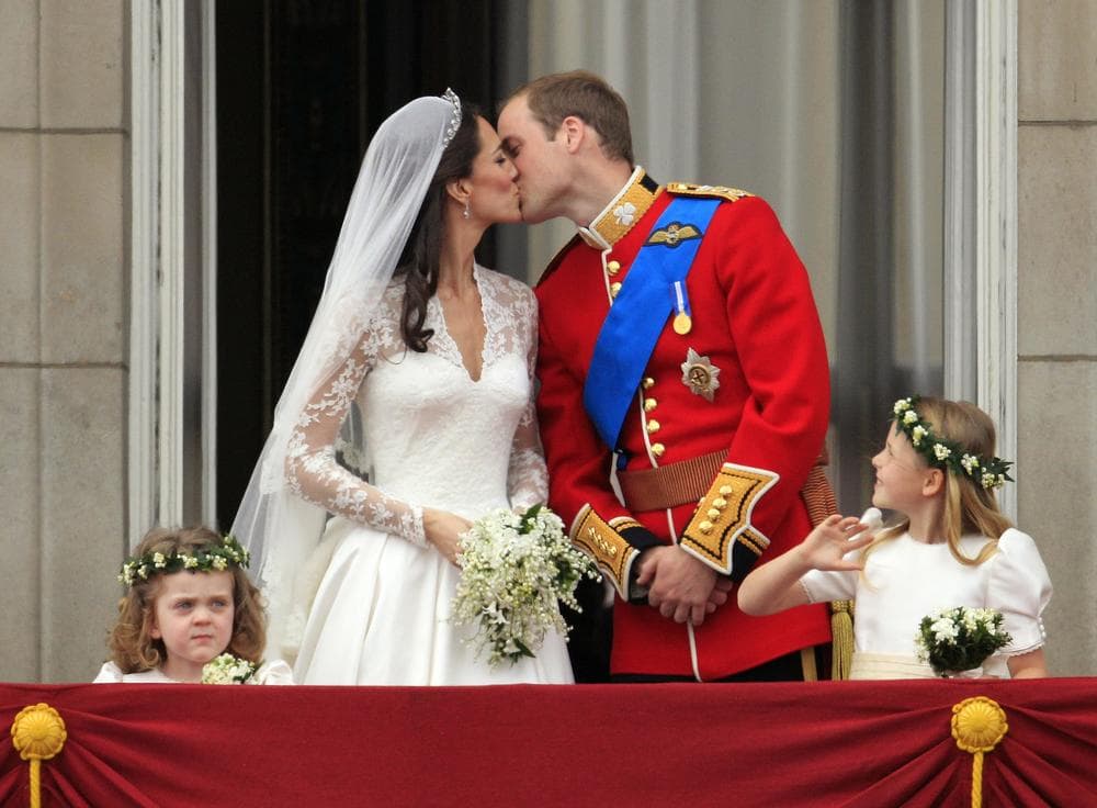 Britain's Prince William kisses his wife Kate, Duchess of Cambridge, on the balcony of Buckingham Palace after the Royal Wedding in London Friday. (AP)