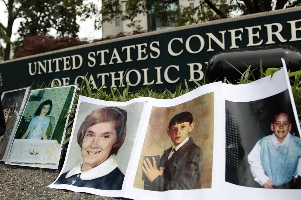 Photographs of children who where allegedly abused by members of the catholic clergy line the sidewalk during a protest outside the headquarters of the U.S. Conference of Catholic Bishops in Washington, Wednesday. (AP)