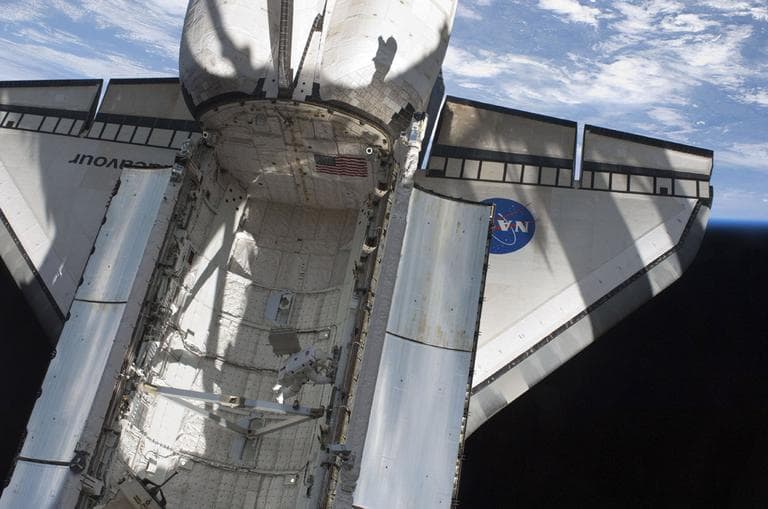 In this image provided by NASA, astronaut Andrew Feustel works in the space shuttle Endeavour's payload bay during the mission's first spacewalk at the International Space Station Friday, May 20. (AP)