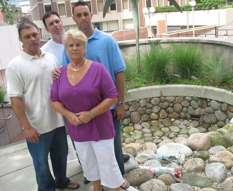 Pat Donahue, front, stands with sons Michael, left, Shawn and Tommy at Boston’s Garden of Peace. Michael Donahue was gunned down in 1982, allegedly by James "Whitey" Bulger or one of his associates. (Martha Bebinger/WBUR) 