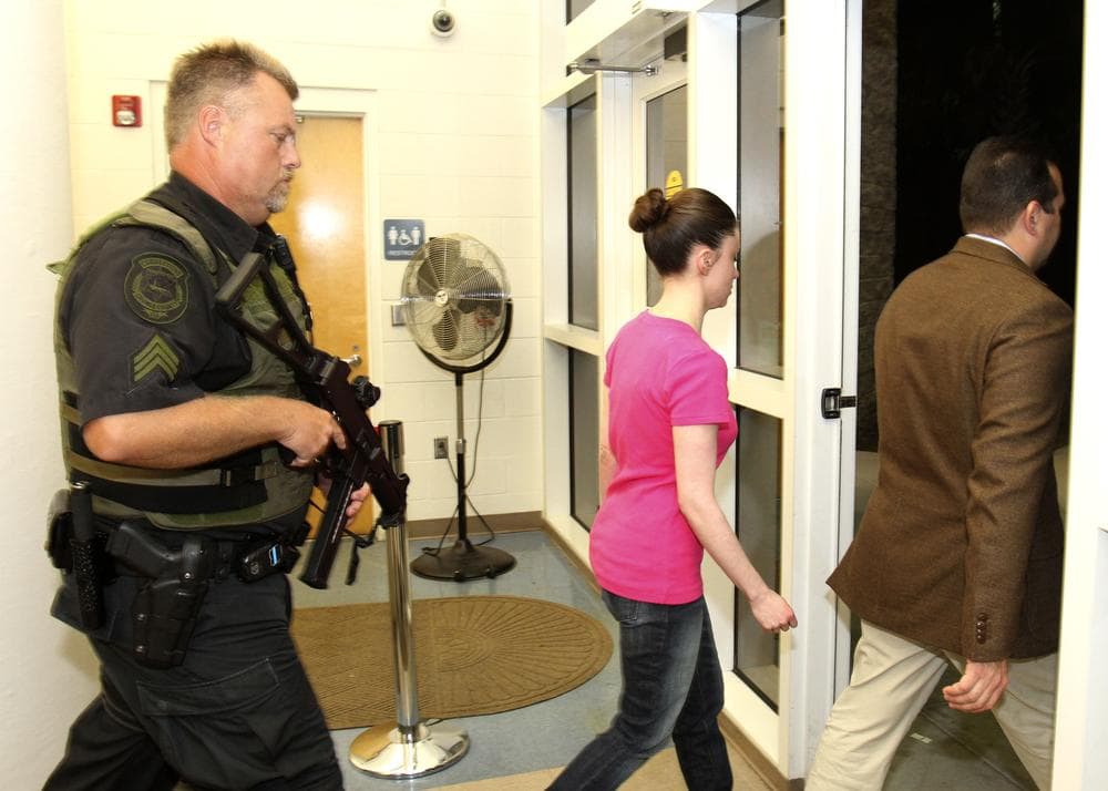 Casey Anthony, center, walks out of the Orange County Jail with her attorney Jose Baez, right, during her release in Orlando, Fla., early Sunday. (AP)