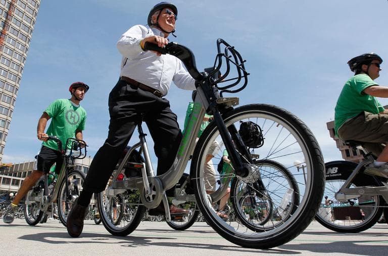 Cyclists depart Boston's City Hall Plaza Thursday as part of a launch of the state's first bike-share program &mdash; Hubway. (AP)