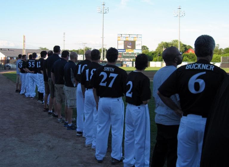 Buckner, right, lines up with the team before a recent game. (Anthony Brooks/WBUR)