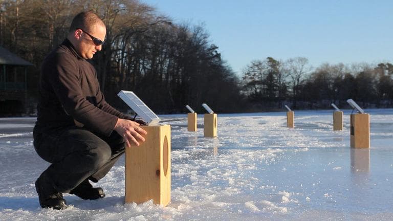 Artist Craig Colorusso arranges his "Sun Boxes" on a frozen pond in Plymouth in February. (Courtesy Kevin Belli)
