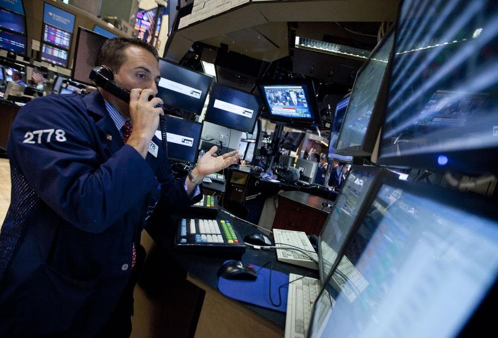 A trader works on the floor of the New York Stock Exchange before close on Monday in New York. (AP)