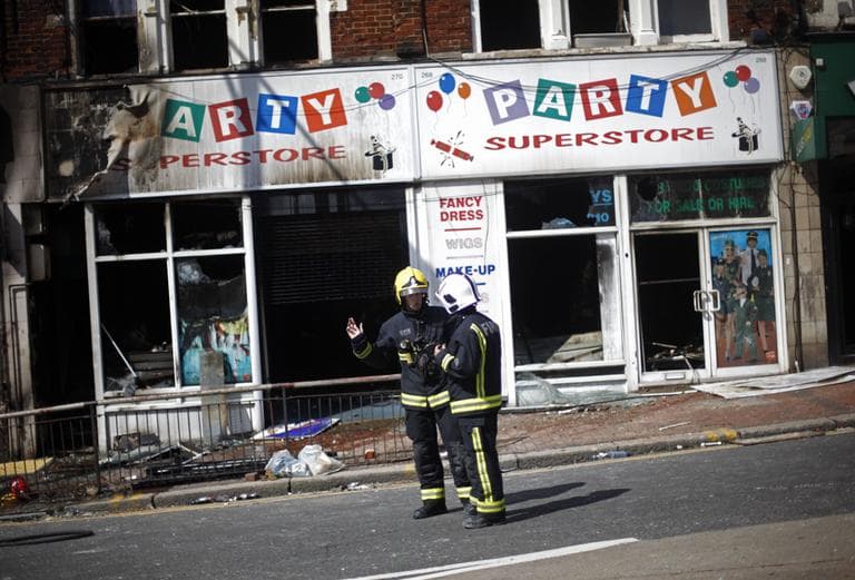 Firemen work in the area of Clapham in the aftermath left by riots in London. Several nights of rioting left trails of looted stores, wrecked cars and burned buildings across London and several other cities. (AP)