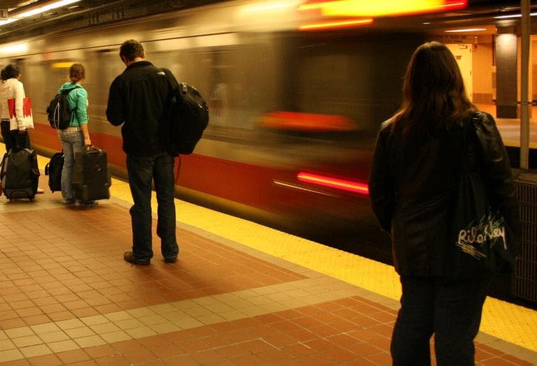 Patrons wait for the T in Cambridge's Central Square. (b a r t/Flickr)