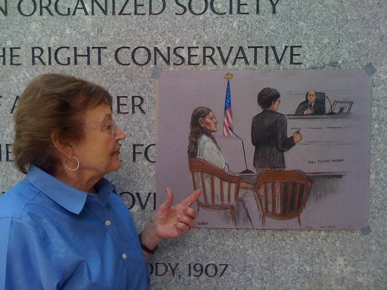 Courtroom sketch artist Jane Flavell Collins looks at her sketch of Michelle Kosilek (pictured seated on the left). (Adam Ragusea/WBUR)