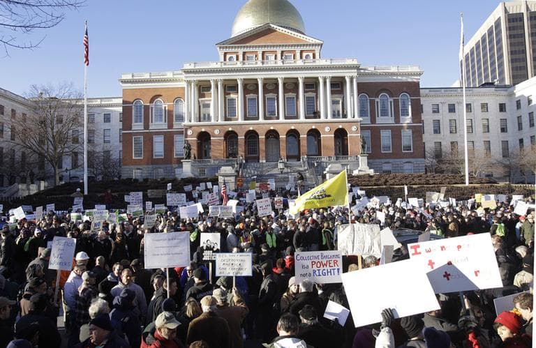 Union workers and supporters of Wisconsin workers as well as people against unions and collective bargaining attend a Massachusetts Teachers Association "Stand Up for Wisconsin Workers" rally outside the State House in February. (AP)