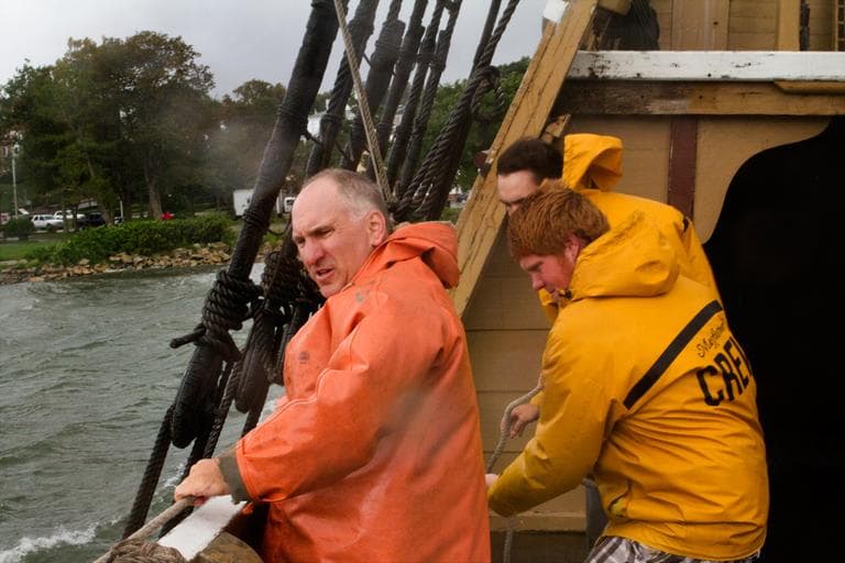 The crew of the Mayflower II, from front, Peter Arenstam, Danny Matthews and Colin Welch, reined in a utility boat Sunday in Plymouth Harbor. (Jesse Costa/WBUR)