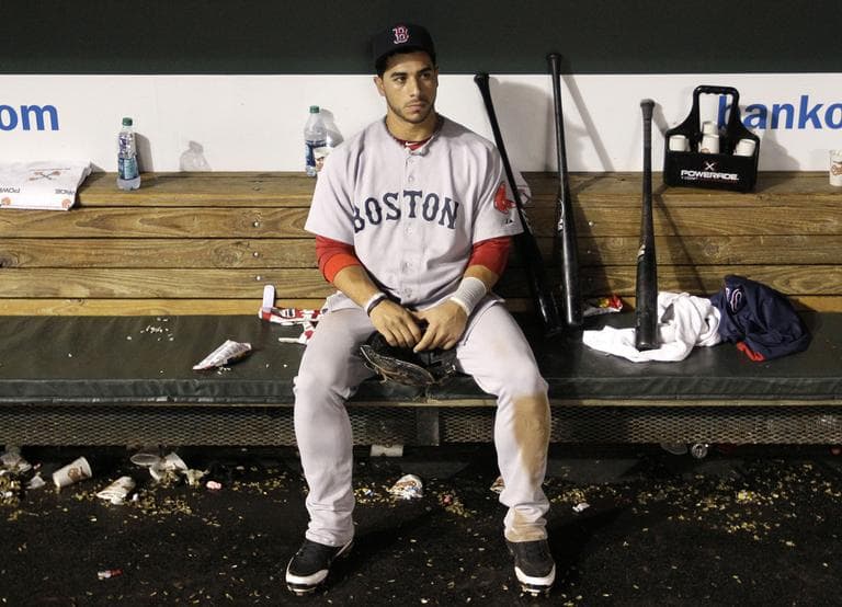Boston's third baseman Mike Aviles sits in the dugout after Boston's loss to the Orioles, Wednesday. (AP)