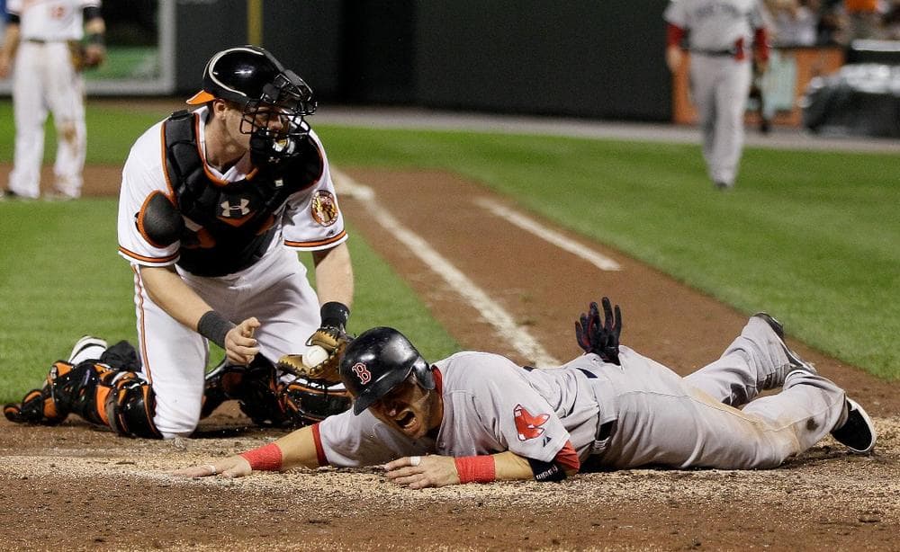 The Red Sox' Marco Scutaro was tagged out at the plate in a crucial eighth-inning play. (AP)