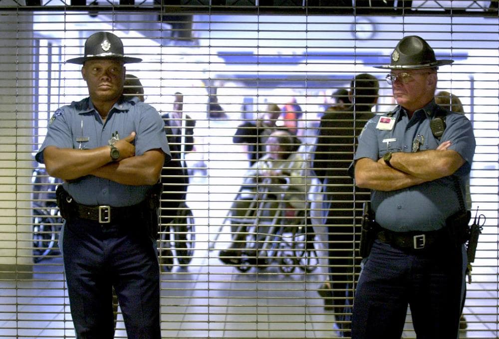 Massachusetts State Police troopers stand in front of the closed entrance to American Airlines gate area as passengers are evacuated at Logan International Airport in Boston on Sept. 11, 2001. A team of law enforcement officials quickly gathered at Logan that day to begin a criminal investigation. (AP)