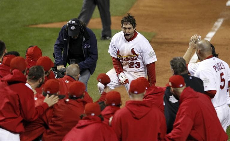 Teammates celebrate with St. Louis Cardinals' David Freese after Freese hit a walk-off home run during the 11th inning of Game 6 of baseball's World Series against the Texas Rangers Thursday, Oct. 27, 2011, in St. Louis. The Cardinals won the game 10-9 to tie the series 3-3. (AP Photo/Eric Gay)
