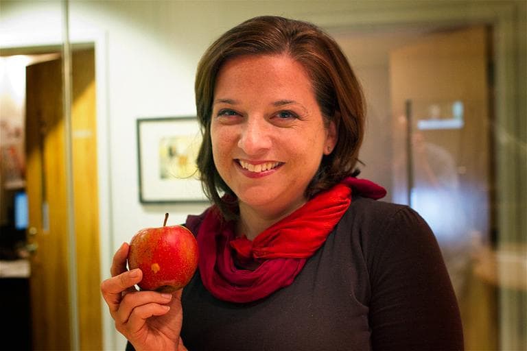 Author Amy Traverso holding an apple at Here &amp; Now studios in Boston. (Jesse Costa/Here &amp; Now)