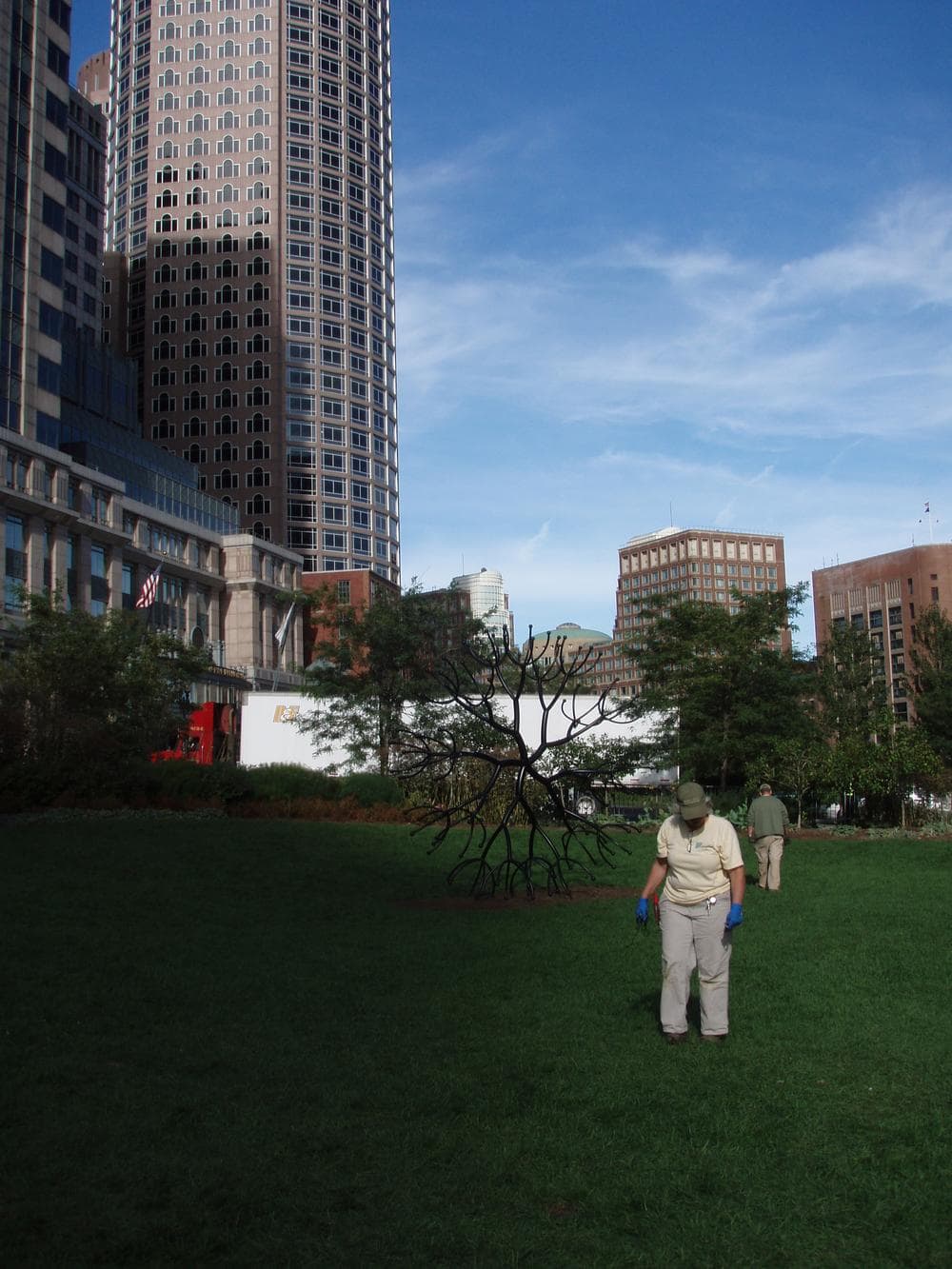 Greenway maintenance workers clean up the area where Occupy Boston members were forcibly removed by police. (Curt Nickisch/WBUR)