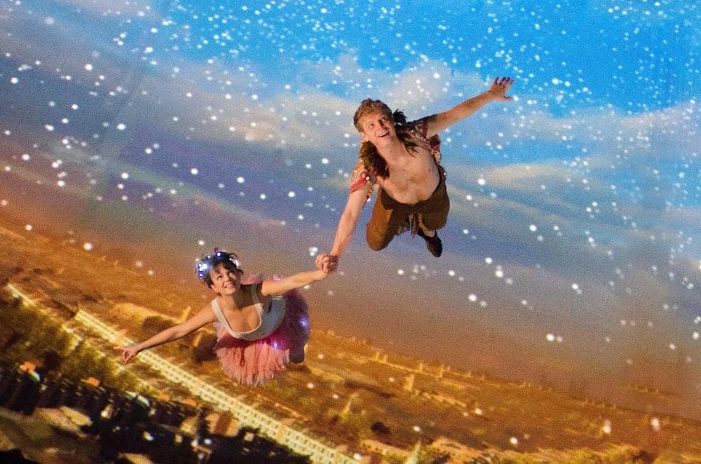 Tinker Bell (Emily Yetter) and Peter Pan (Chuck Bradley) fly to Neverland in the threesixty° stage production of "Peter Pan," performed in the theater tent on Boston’s City Hall Plaza. (Andrew Brilliant/Brilliant Pictures Inc.)