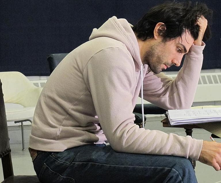One of the actors in 'Captors' studies his script during rehearsal (Andrea Shea/WBUR)