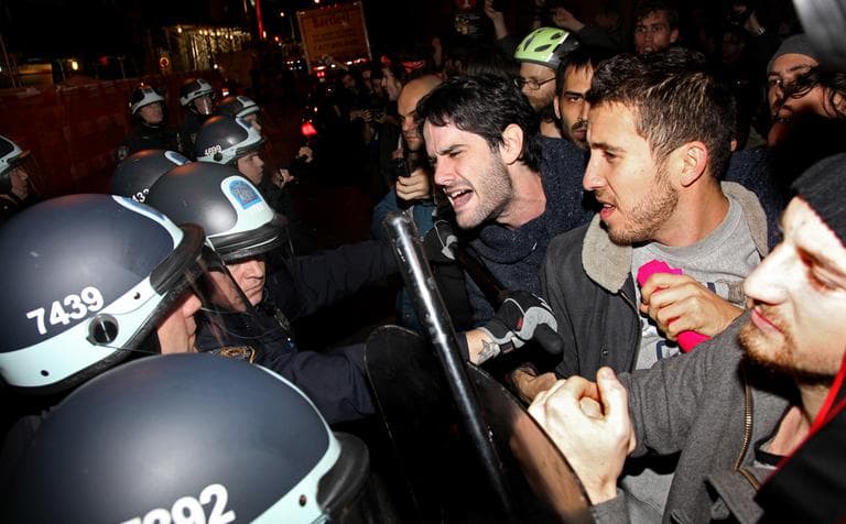 Occupy Wall Street protesters clash with police at Zuccotti Park after being ordered to leave their longtime encampment in New York, early Tuesday. At about 1 a.m. Tuesday, police handed out notices from the park's owner, Brookfield Office Properties, and the city saying that the park had to be cleared because it had become unsanitary and hazardous. Protesters were told they could return, but without sleeping bags, tarps or tents. (AP)