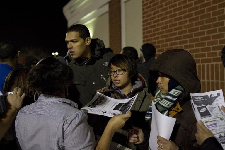 At the head of the line, a Best Buy employee distributes tickets to purchase one of the popular Sharp 42-inch televisions which were on sale for $199.99 each. Best Buy at South Bay Plaza in Dorchester, Mass. had only 44 in stock. (Luke Boelitz for WBUR)