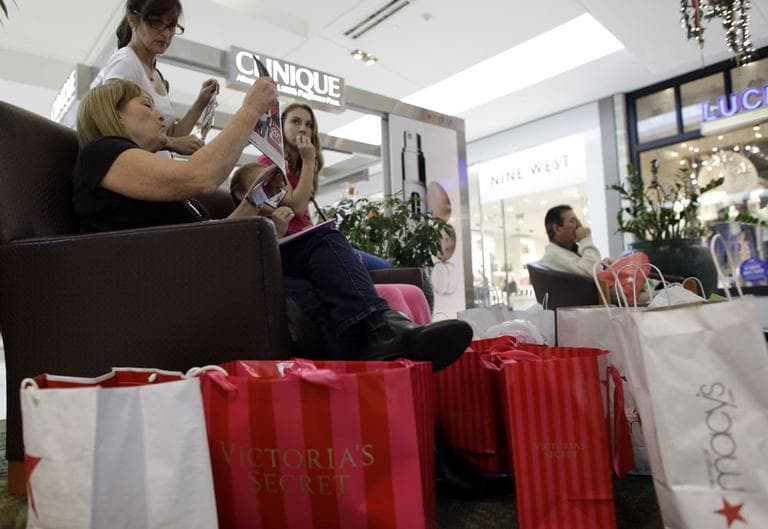 Robin Cruz of Miami, left, sorts through her coupons with Rosi Duell, center, while taking a break from shopping at Dadeland Mall, Friday, Nov. 25. (AP)