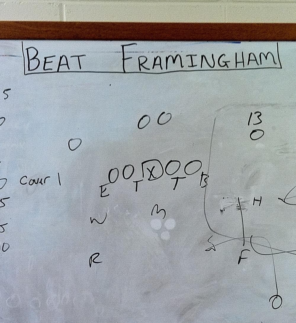 The season's overall message is front and center in the Natick HS coaches' room. (Curt Nickisch/WBUR)