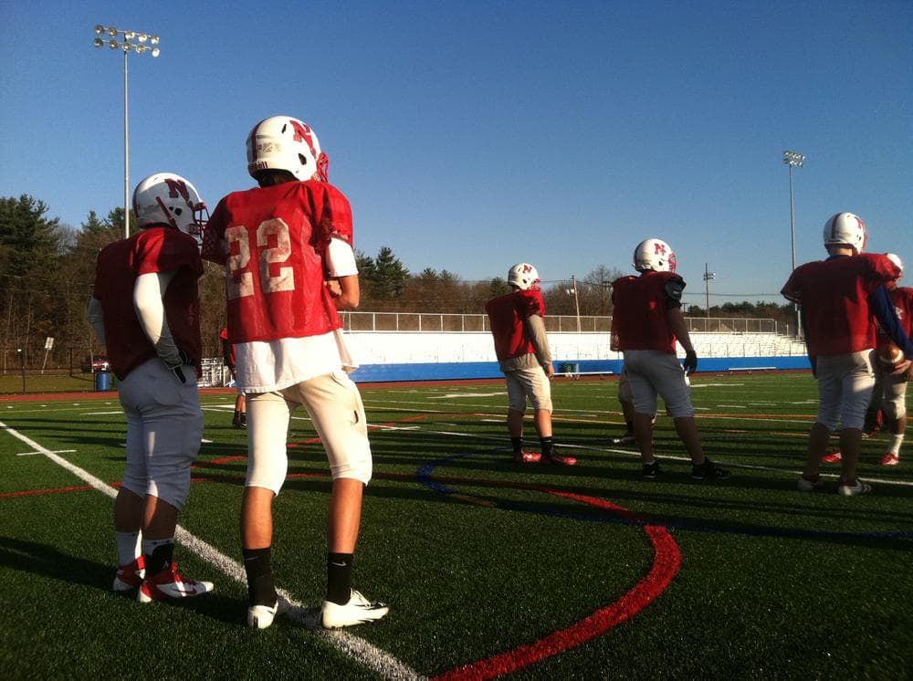 Natick High School quarterback Troy Flutie practices in a jersey with the same number &mdash; 22 &mdash; his uncle, Doug Flutie, wore at Boston College. (Curt Nickisch/WBUR)
