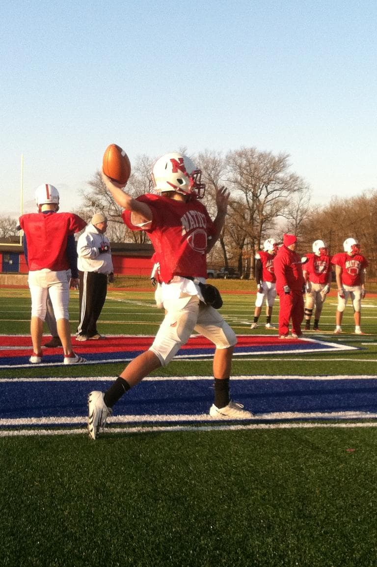 Troy Flutie practices swing passes ahead of Natick's game against Framingham. (Curt Nickisch/WBUR)