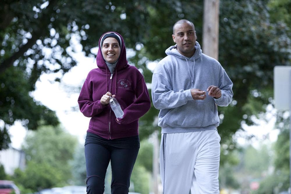 Nawal Aoude, a pediatric respiratory therapist, left, and her husband Nader go for a walk in a scene from the TLC series, "All-American Muslim." (AP/Discovery)