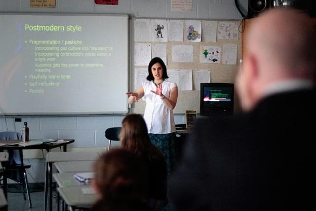 Alison Courchesne conducts her Framingham High class while Stand for Children's Jason Williams, right, evaluates her. (Jesse Costa/WBUR)