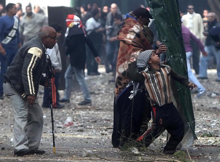 Egyptian protesters throw rocks at military police during clashes near Cairo's downtown Tahrir Square, Egypt, Friday, Dec. 16, 2011. Activists say the clashes began after soldiers severely beat a young man who was part of a sit-in protest outside the Cabinet building. (AP)