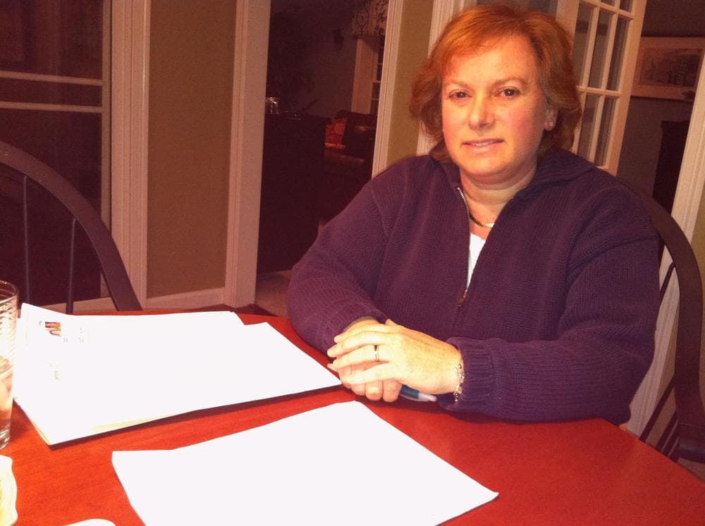 Dr. Sarah Bechta tries to compare tiered health plans. (Martha Bebinger/WBUR)