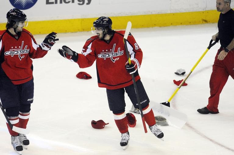 Washington Capitals' Mathieu Perreault, center, shakes hands with Marcus Johansson, of Sweden, after completing a hat trick against the Bruins during the third period Tuesday. (AP)