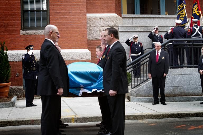 Pallbearers carry Kevin White's casket into St. Cecilia Church. (Jesse Costa/WBUR)
