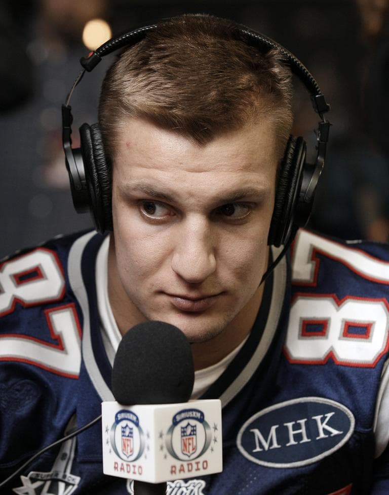 Patriots tight end Rob Gronkowski does an interview during a news conference on Wednesday. The 'MHK' on the right side of his football jersey are the initials of Patriots' owner Robert Kraft's late wife, Myra Hiatt Kraft. (AP)
