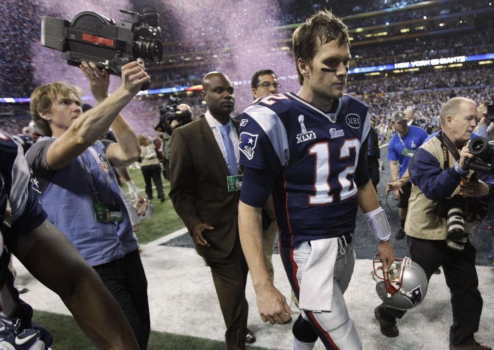 Patriots quarterback Tom Brady walks off the field after the Patriots' 21-17 loss to the Giants. (AP)