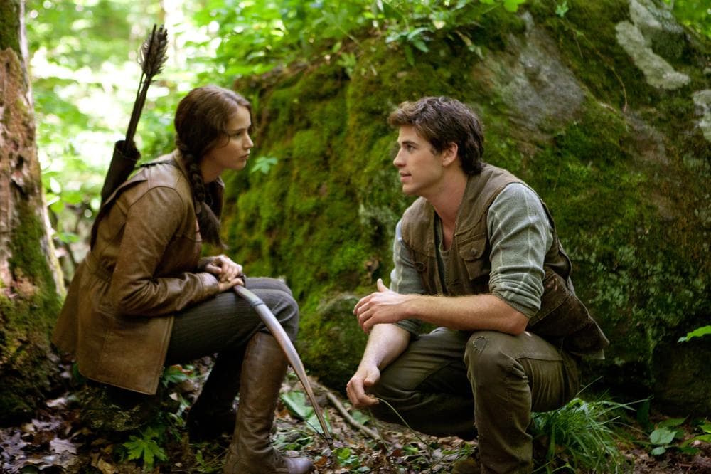 Jennifer Lawrence portrays Katniss Everdeen, left, and Liam Hemsworth portrays Gale Hawthorne in a scene from "The Hunger Games." (AP/Lionsgate, Murray Close)