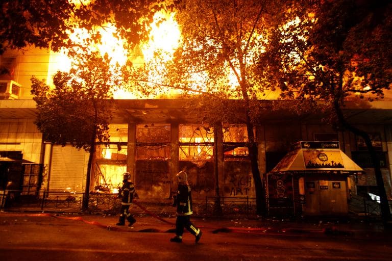 A cinema burns in Athens, Sunday, Feb. 12, 2012. (AP)