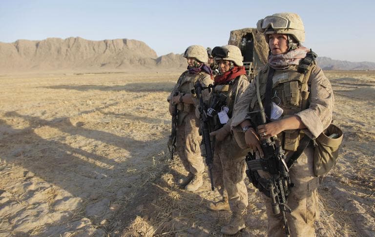 In this Aug. 10, 2009 photo, U.S. Marine Female Engagement Team members Lance Cpl. Mary Shloss, right, of Hammond, Ind., Sgt. Monica Perez,, center, of San Diego, Calif. and Cpl. Kelsey Rossetti, of Derry, N.H. wait for the signal to begin their patrol with Golf Company, 2nd Batallion, 3rd Regiment of the 2nd MEB, 2nd MEF in the Helmand Province of Afghanistan. The team's mission is to engage local Afghan women to find out and address their concerns. On Thursday, Feb. 9, 2012, Pentagon rules will catch up a bit with reality, recommending to Congress that women be formally allowed to serve in more jobs closer to the front lines. (AP)