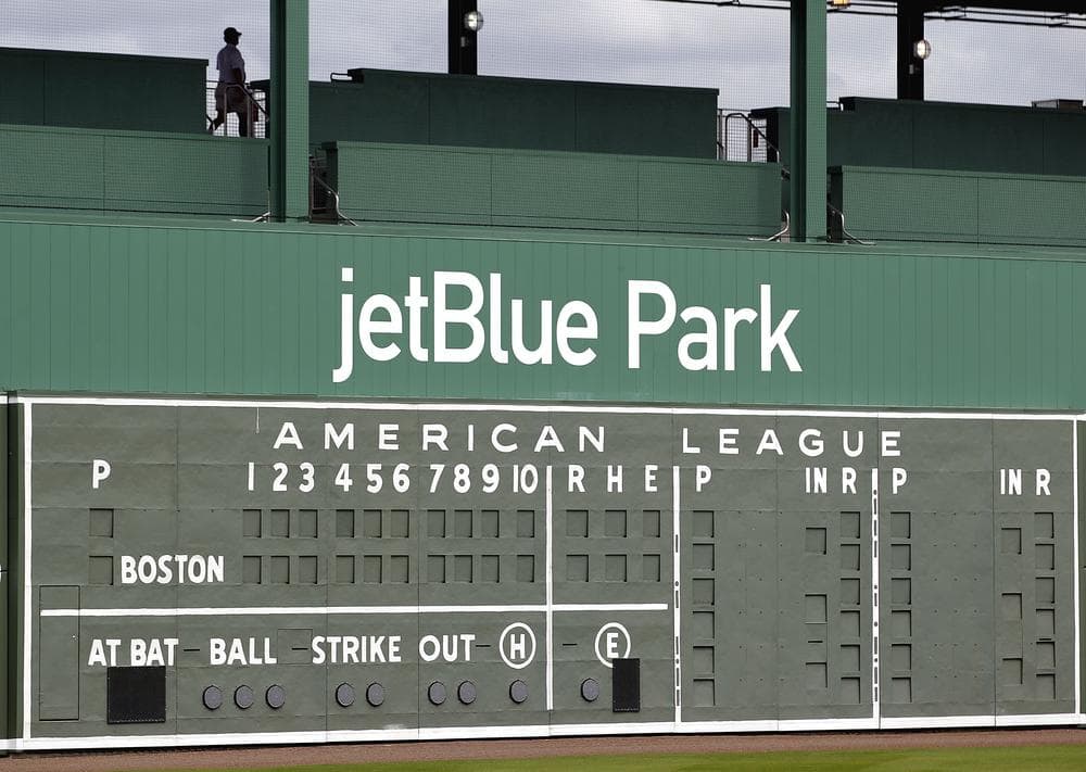 A restored manual scoreboard once used at Fenway Park for almost three decades now decorates the outfield wall of the Red Sox's new spring training baseball stadium in Fort Myers, Fla. (AP)