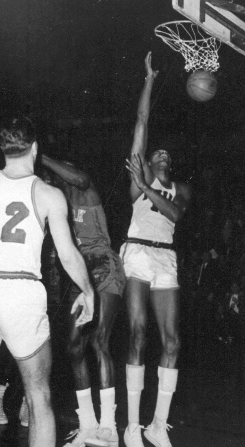 Philadelphia Warriors' Wilt Chamberlain, right, scores his 100th point, setting an NBA record, during a game against the New York Knicks in Hershey, Pa., March 3, 1962. (AP)