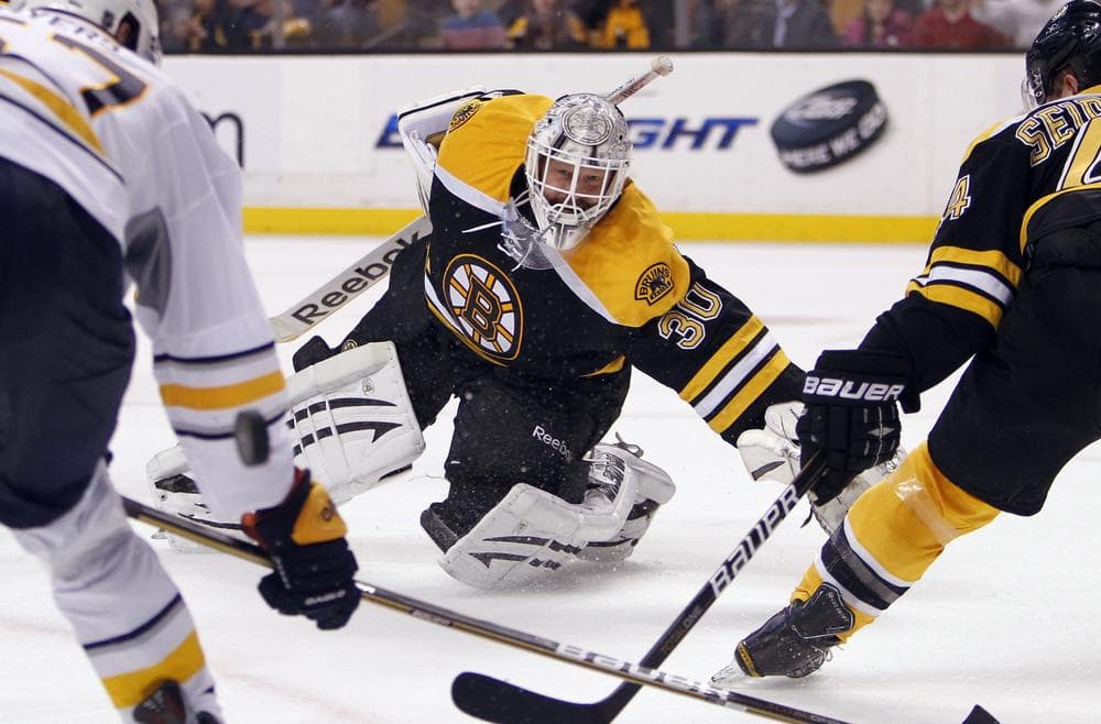Bruins goalie Tim Thomas watches as the puck deflects behind Sabres' Tyler Myers as Bruins' Dennis Seidenberg defends in the third period of last night's home game. (AP Photo)