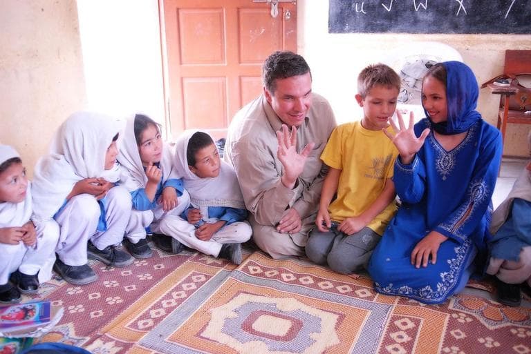Greg Mortenson, his son Khyber, and daughter, Amira Mortenson, with students at Gultori War refugee school, Bromolo Colony, Karakoram mountains. (PRNewsFoto/Central Asia Institute, Deirdre Eitel)