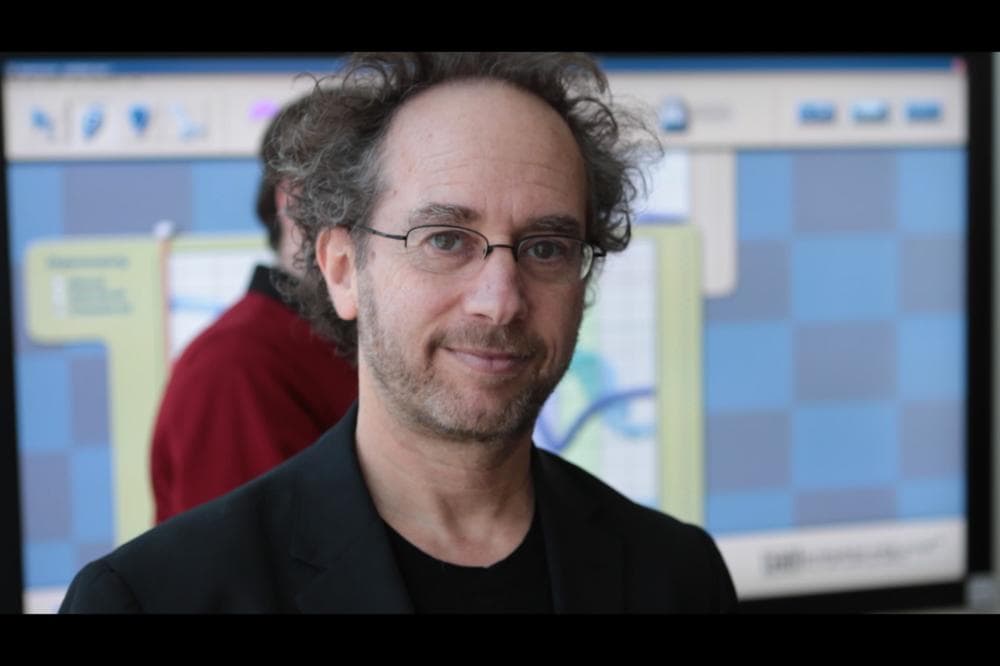 Tod Machover, with the Hyperscore software on a large screen in the background. (Jesse Costa/WBUR)