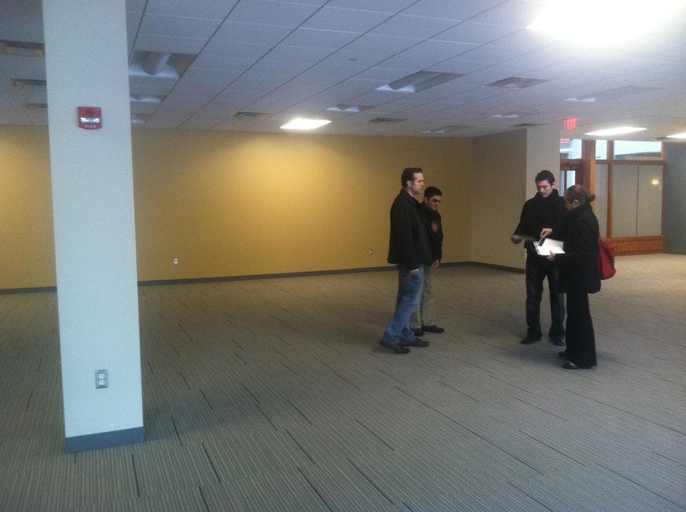 OfficeDrop employees check out "Class A" office space in Kendall Square. (WBUR/Curt Nickisch)