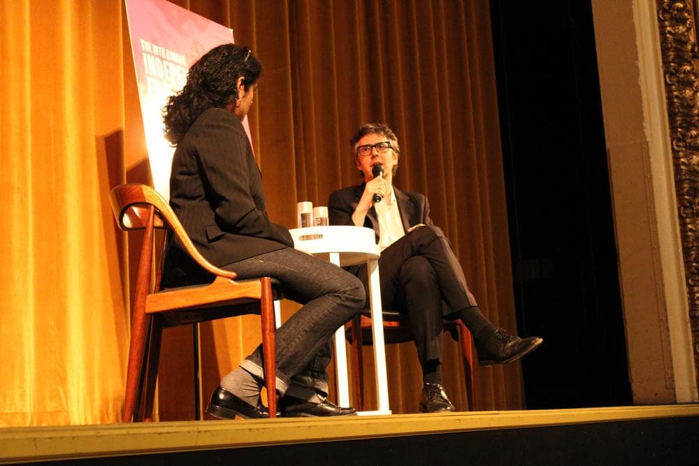 Ira Glass on stage at the Somerville Theatre with WBUR's Meghna Chakrabarti on Wednesday night. (Lisa Tobin/WBUR)