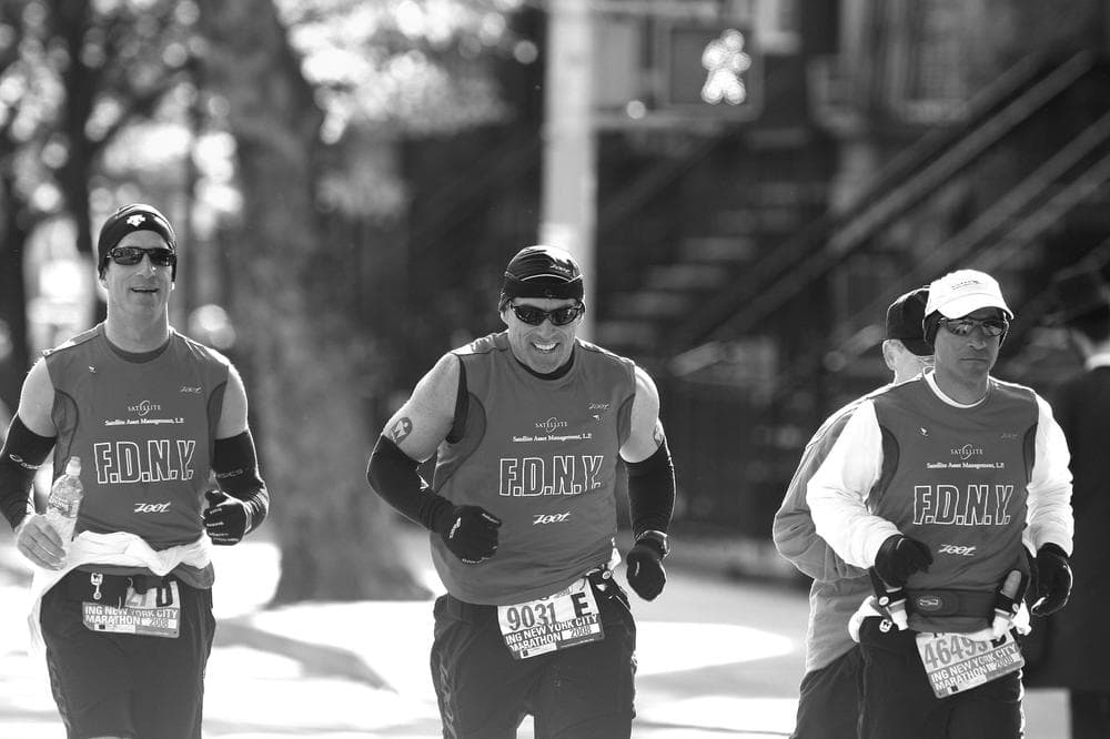 Less than three years after he was run over by a bus, Matt Long (center) makes his way through Brooklyn on his way to finishing the 2008 NYC marathon. (Credit:  Victor Sailer)