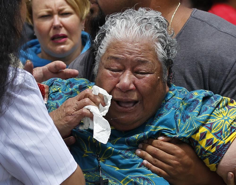 Junior Seau's mother, Luisa Seau, is comforted in the driveway of her son's home in Oceanside, Calif where the former NFL star was found dead on May 2. (AP)