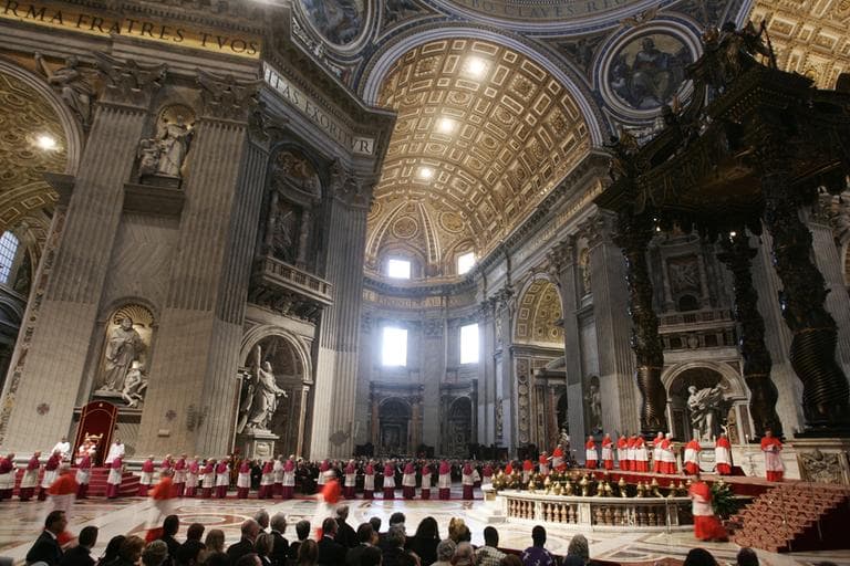 Pope Benedict XVI sits in background left during the Good Friday Passion Mass celebrated in St. Peter's Basilica, at the Vatican. (AP)